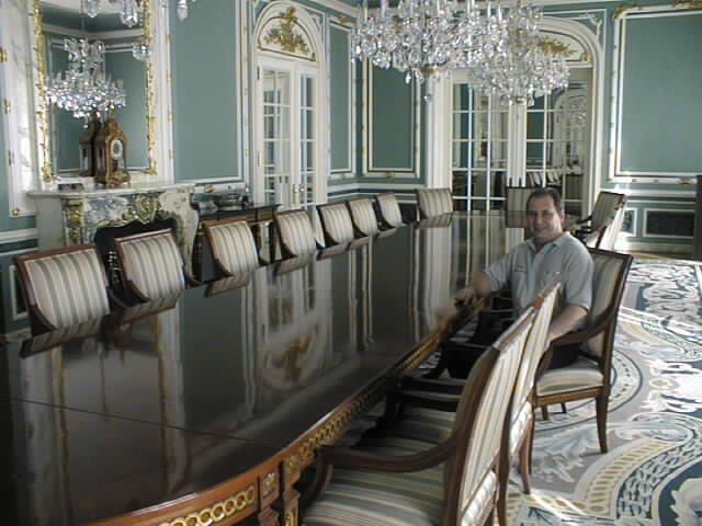 Above, Larry Manoly sits at the table he restored in Alexander Graham Bell's home in Washington, D.C.